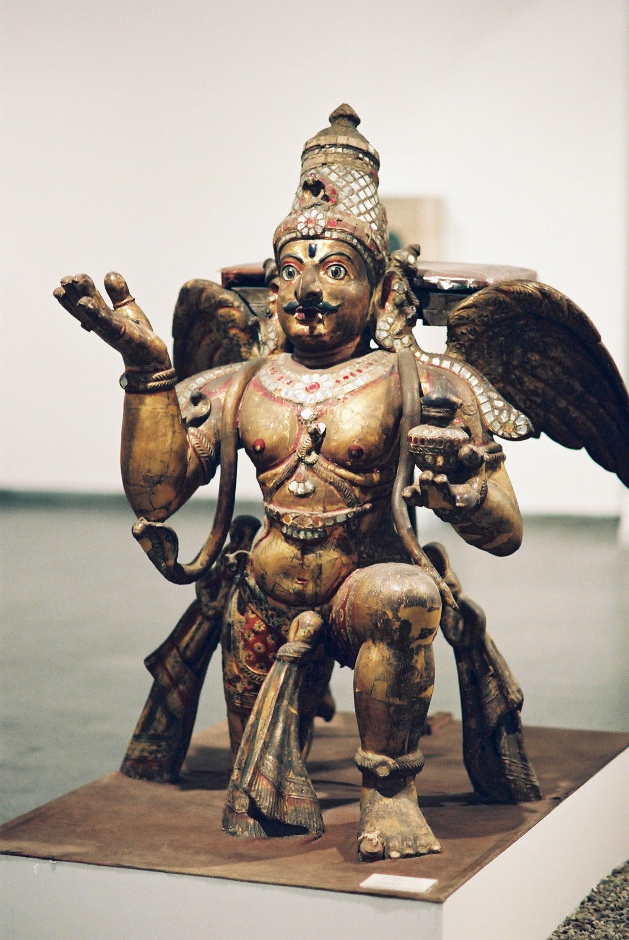 Gilt wood sculpture of Garuda, half man and half eagle, kneeling with wings spread